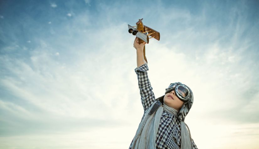 47018234 - little boy with wooden airplane